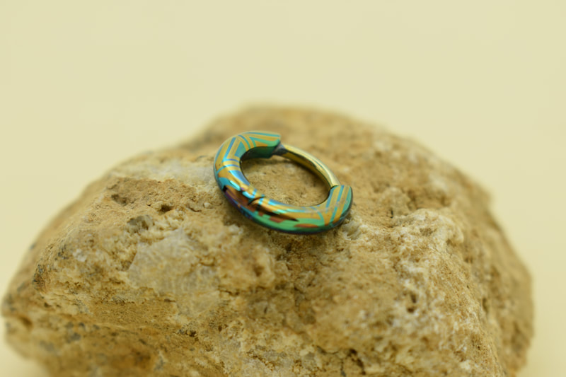 look at the amazing detail that we can acheave with our patterning process in medical grade titanium helix clickers, ear rings, and septum rings